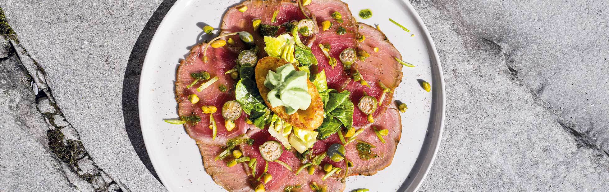 Tuna carpaccio with Mini Rösti Boats, basil espuma and pistachios