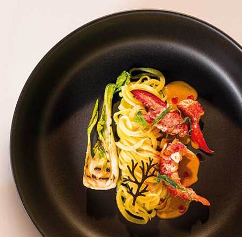 Potato tagliatelle with paprika lobster, lovage, sepia algae and grilled pak choi Image