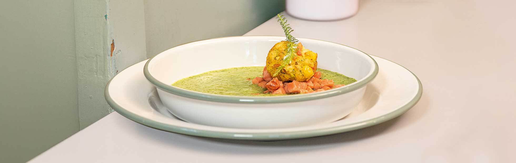 Potato and wild garlic soup with vegetable balls on fried Tsar-cut salmon cubes