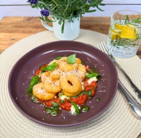 Ciambelline di patate 11er su salsa di pomodoro e mozzarella con parmigiano e basilico Image