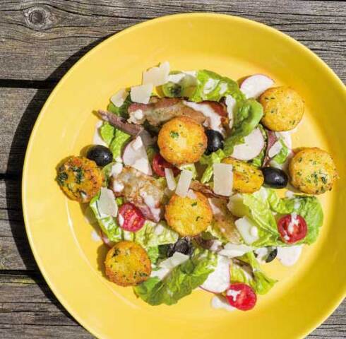 Caesar salad with crispy garlic Mini Rösti and fried bacon Image