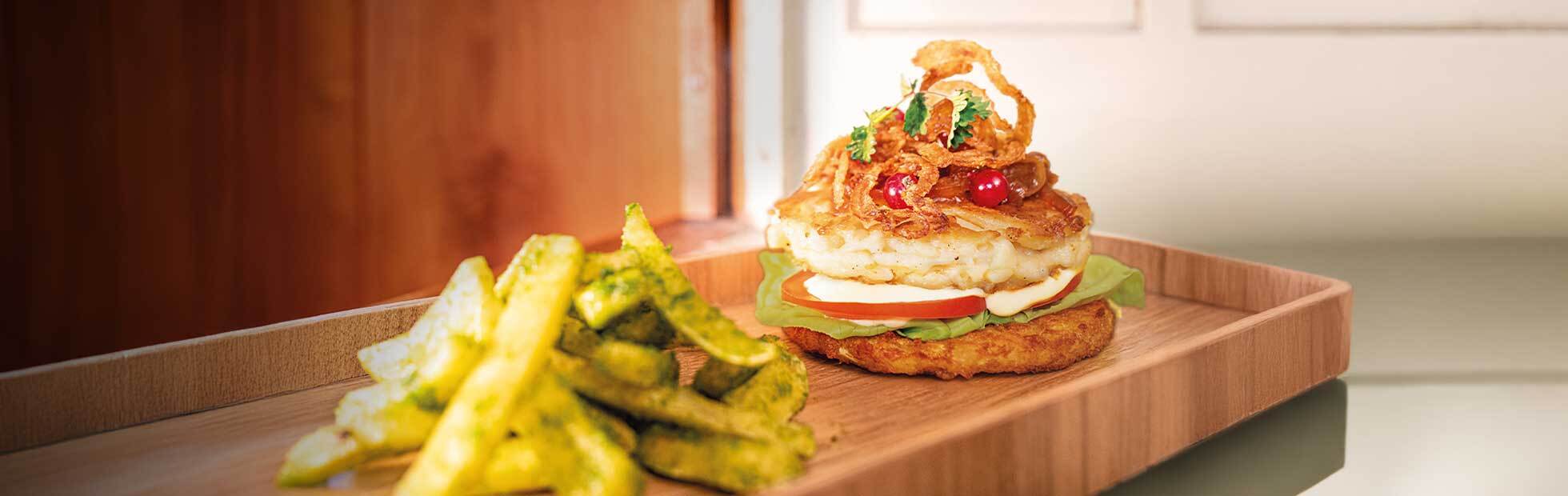 Rösti and cheese spaetzle burger with balsamico-mustard mayonnaise and wild garlic French fries
