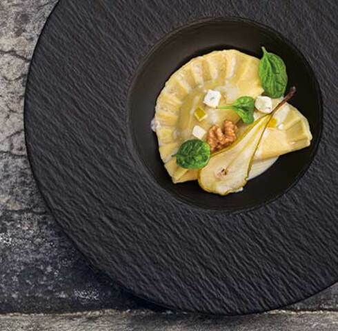Schlutzkrapfen made from potato dough with a spinach, pear and black pudding filling, Gorgonzola cream and roasted walnuts Image