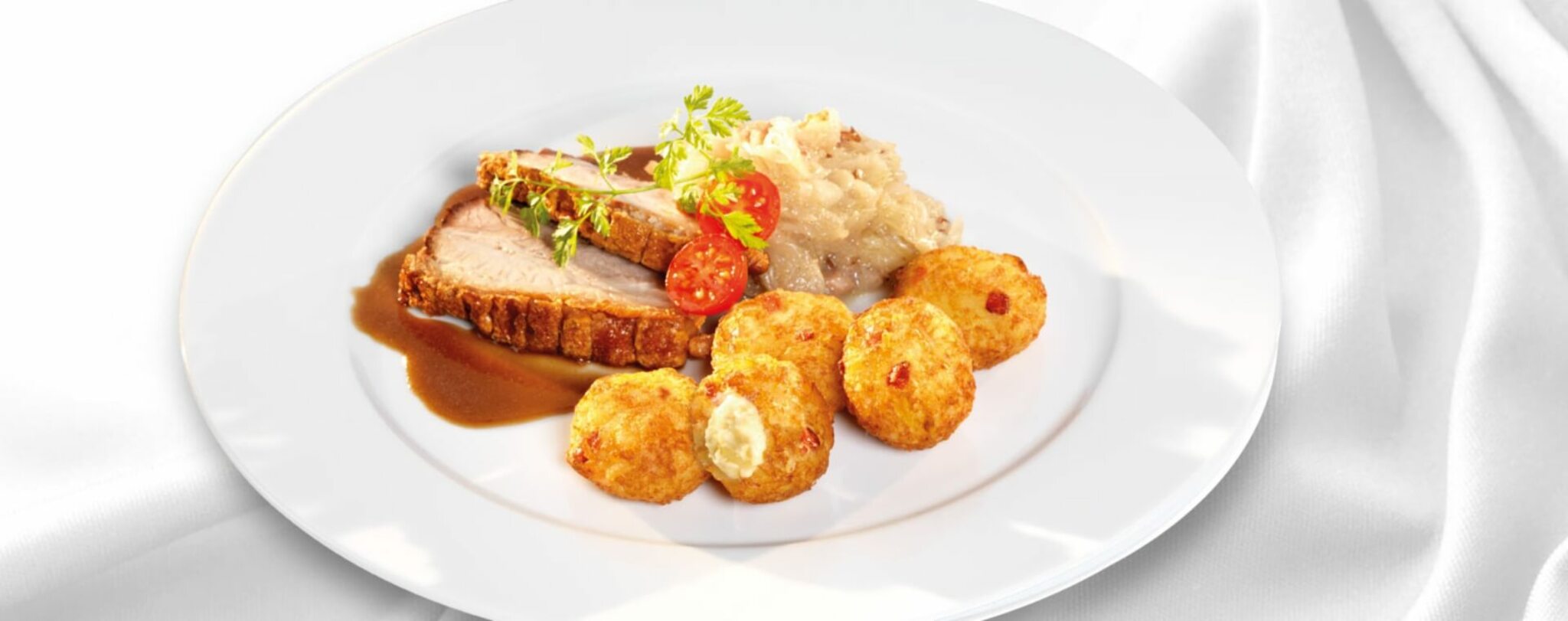 11er Rösti-Bergkäse Schmankerl mit Krustenbraten und Sauerkraut